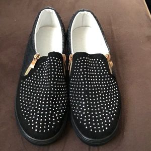 Brand New without tags eye catching black slip ons